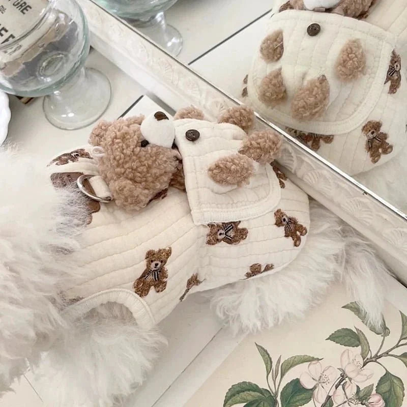Bear print dog harness vest with its plush teddy bear shown beside a mirror