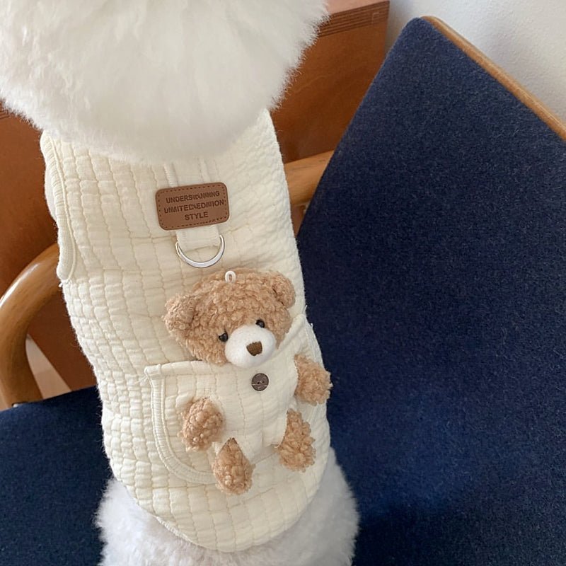 Dog wearing the solid white harness vest with the teddy bear pocket on its back