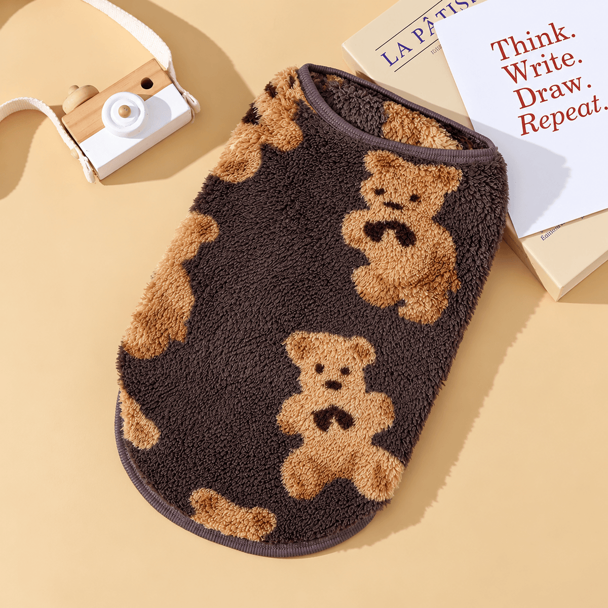 Brown teddy bear fleece dog vest with tan bears laid flat.