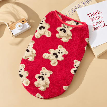 Red teddy bear fleece dog vest with cream bears laid flat.