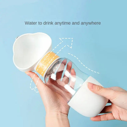 Hand lifting the white cloud-shaped cup off the travel dog water bottle.