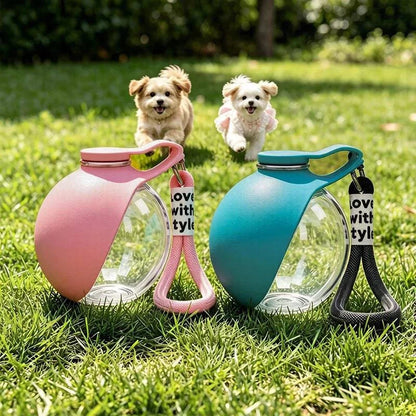 Pink and blue travel dog water bottles on grass with two small dogs running toward them.