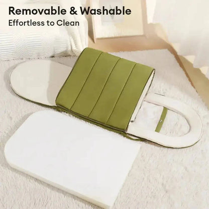 The cave bed with its cover peeled back from the base cushion, captioned removable and washable.