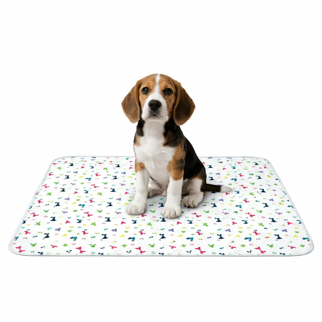 Beagle puppy sitting on the white patterned washable pee pad.