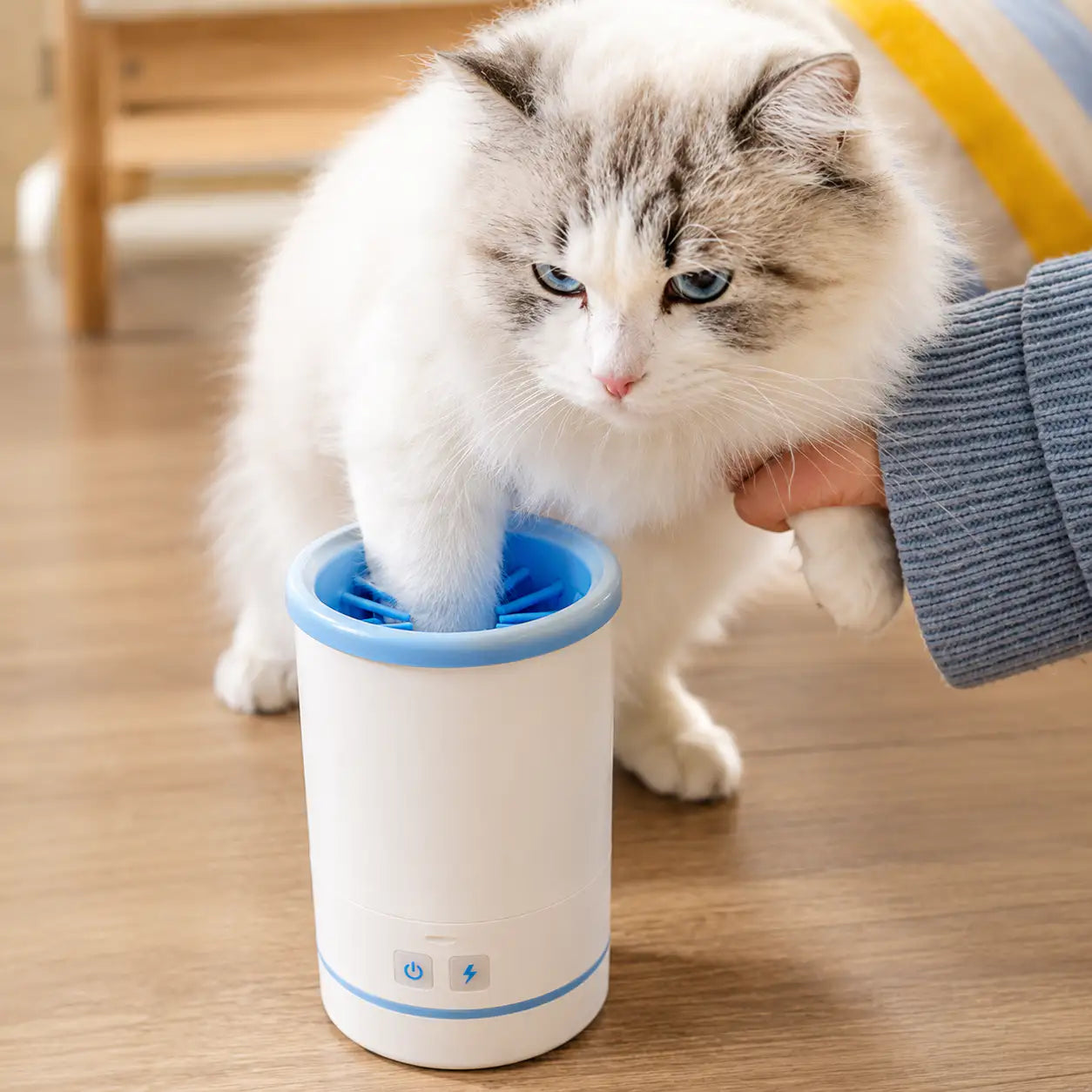 White Noblias Automatic Paw Washer showing the compact device with rotating brushes for cleaning pet paws.